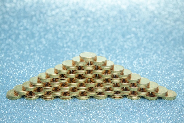 A visual representation of stacked coins and dollar bills arranged to resemble a safety net, symbolizing the protection offered by a well-funded emergency fund.