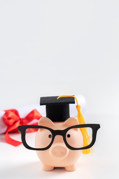 A close-up shot of a piggy bank with graduation caps scattered around it, symbolizing saving for college education.