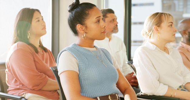 A group of diverse teachers participating in a professional development workshop, actively engaged in discussions and collaborative activities. The setting is a bright, modern training room with interactive whiteboards and comfortable seating.