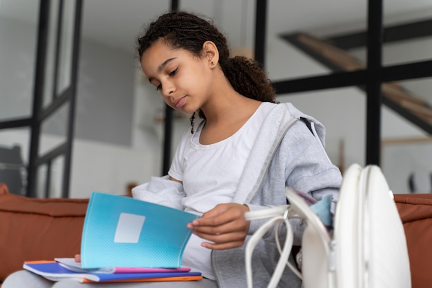 A student excitedly opening an acceptance letter from a university, with a laptop in the background showing a college application portal, illustrating the culmination of the application process.