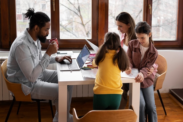 A diverse IEP team, including parents, teachers, and specialists, are gathered around a table, reviewing a student's IEP document with focused attention and collaborative discussion.