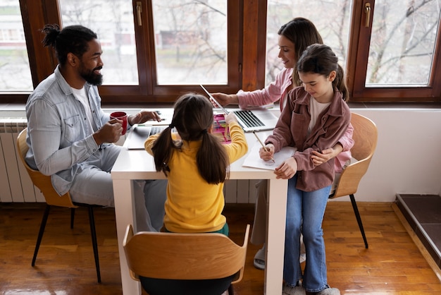 A group of diverse students working collaboratively in a classroom setting, with a teacher facilitating the discussion. The scene conveys a sense of engagement and active learning.
