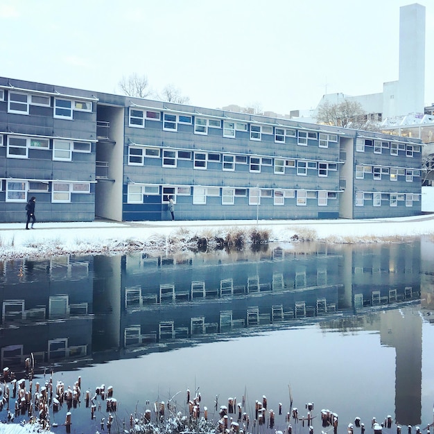 A split image showing a well-funded school with modern facilities on one side, and a poorly funded, dilapidated school on the other, illustrating the disparity in educational resources due to varying property tax revenues.