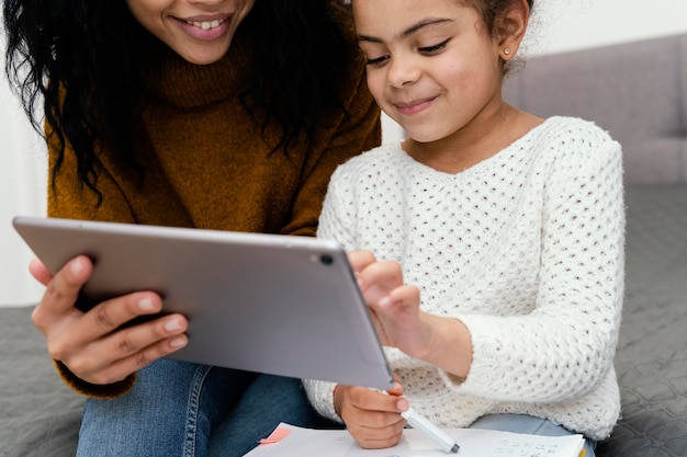 A teacher working one-on-one with a student, using a tablet to track progress and personalize the learning experience, illustrating the benefits of data-driven instruction.