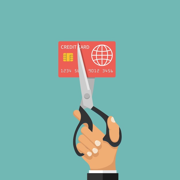 A person using scissors to cut a credit card in half, symbolizing reducing expenses and taking control of finances.