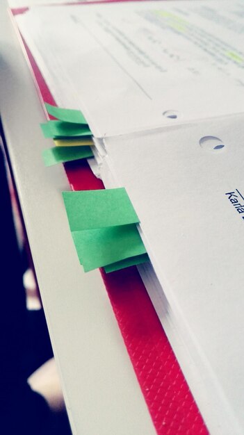 A close-up of a credit report document with highlighted sections indicating errors and discrepancies, with a pen pointing at one of the highlighted areas. The image conveys attention to detail and the need for thoroughness.
