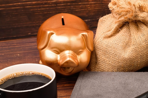 A close-up shot of a piggy bank overflowing with coins and dollar bills, with a calculator and a coffee cup in the background, symbolizing the potential savings from reducing daily expenses.