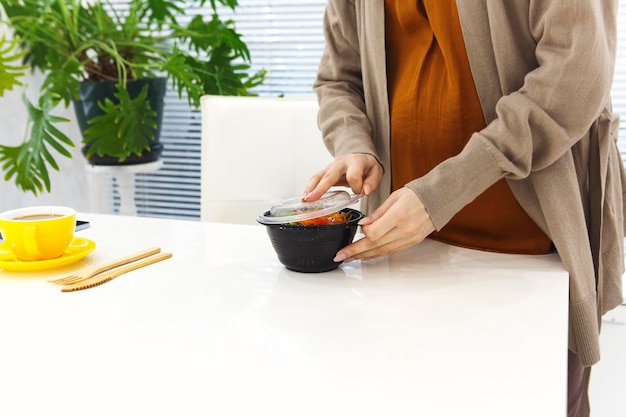 A person preparing a healthy meal at home, symbolizing the cost-saving strategy of cooking at home in financial minimalism.