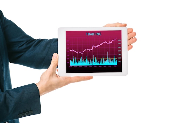 An upward angled shot capturing a person holding a tablet displaying a stock market chart. The background is blurred, hinting at a vibrant and bustling city scene, symbolizing the opportunities and dynamic nature of stock options and RSUs.