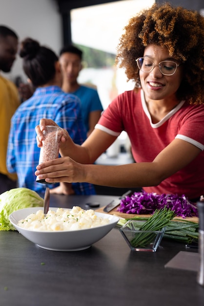 A close-up of a diverse team participating in a healthy cooking class, preparing a colorful salad with fresh vegetables. The instructor stands nearby, demonstrating proper techniques.