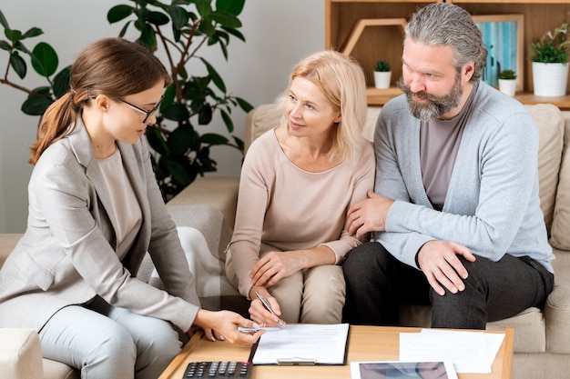 A financial advisor sitting across from a young family, discussing life insurance options and financial planning strategies. The image conveys trust, expertise, and personalized advice.