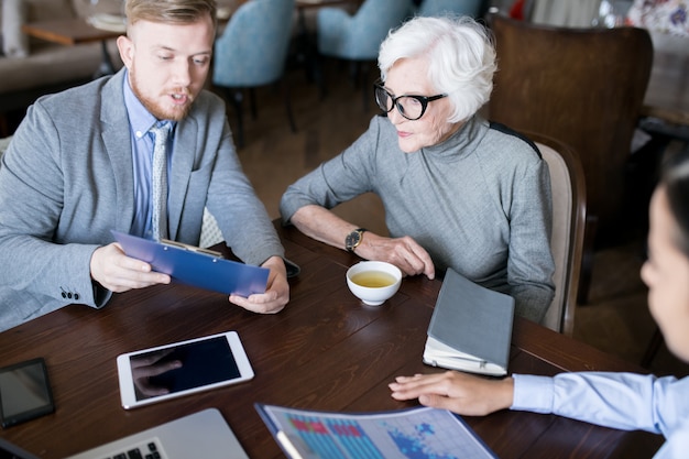 A financial advisor meeting with an employee to discuss retirement planning and investment strategies, highlighting the personalized support offered by financial wellness programs.