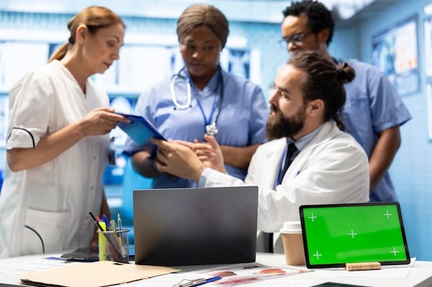 A diverse group of employees discussing healthcare options with a benefits administrator, with a focus on digital tools and resources.